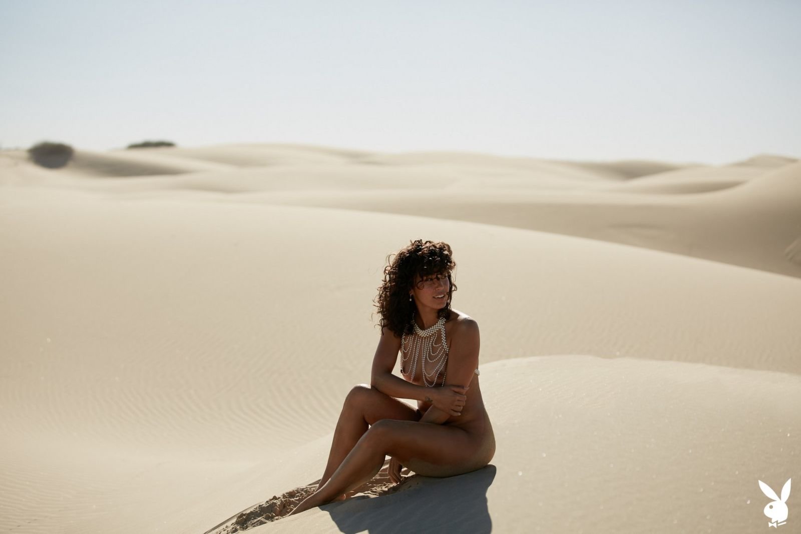 Fo Porter posing nude in front of a mirror in the desert