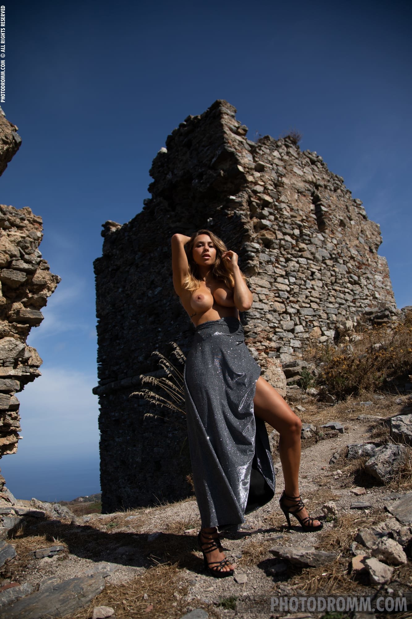 Gorgeous Goldie slips out of her evening dress and poses at an ancient ruin