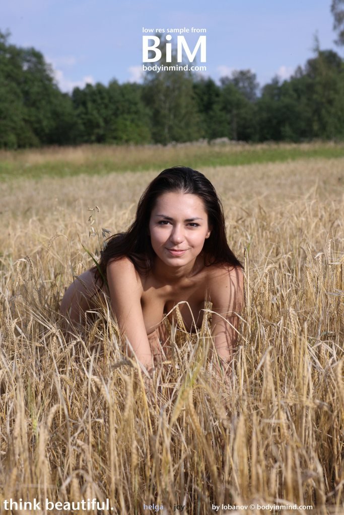 Busty farmgirl Helga posing naked in the field