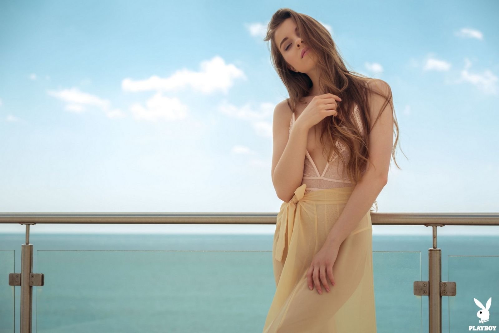 Young beauty Kate Chromia poses nude on a beach balcony