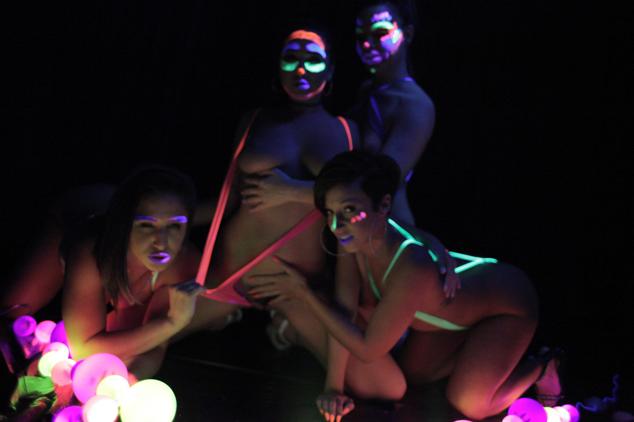 Fun loving pornstars naked in glow paint enjoy strap-on lesbian group sex