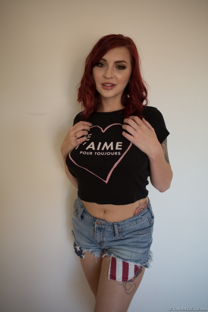 Redhead babe Amber Ivy bares her natural tits and takes off her tight shorts