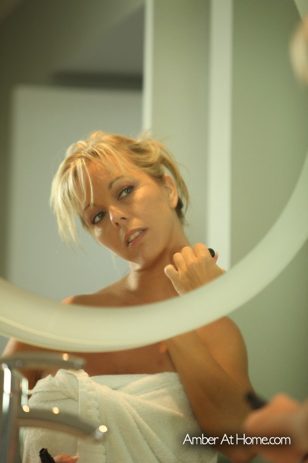 Dirty blond amateur Amber Lynn Bach admires her nude body in a bathroom mirror