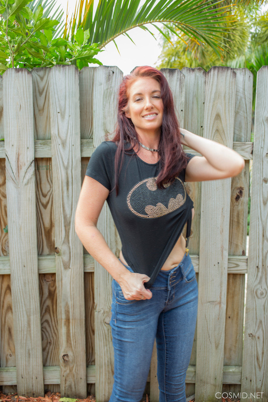 Hot redhead Andy Adams loses her t-shirt & jeans in the yard to pose naked