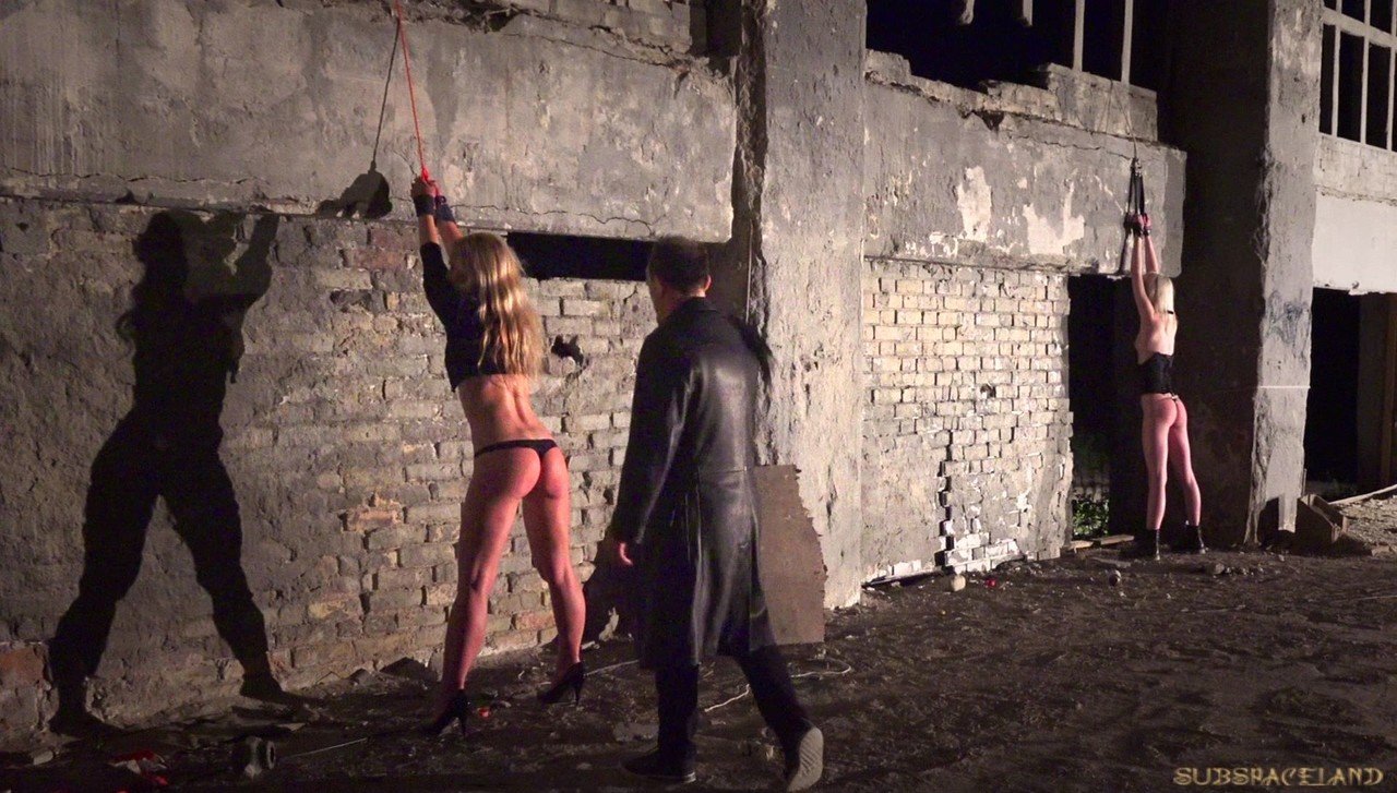 Sex slaves giving their BDSM handler a double blowjob after a whipping