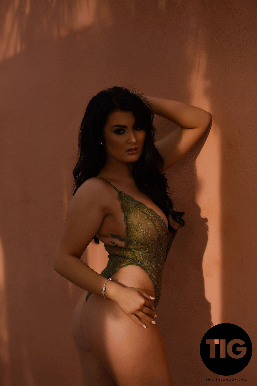 Curvaceous British model Ashleigh Gee removes sheer bodysuit outside and poses