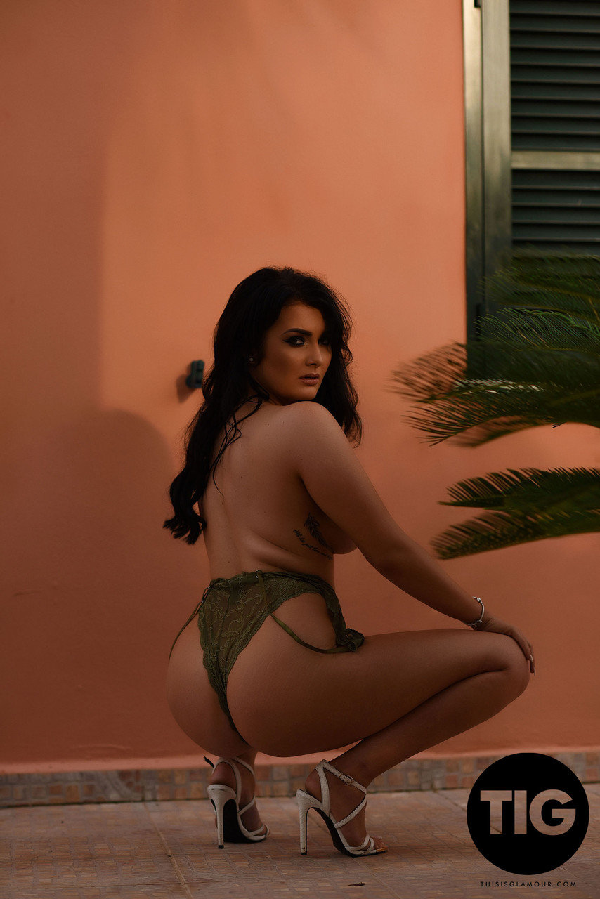 Curvaceous British model Ashleigh Gee removes sheer bodysuit outside and poses