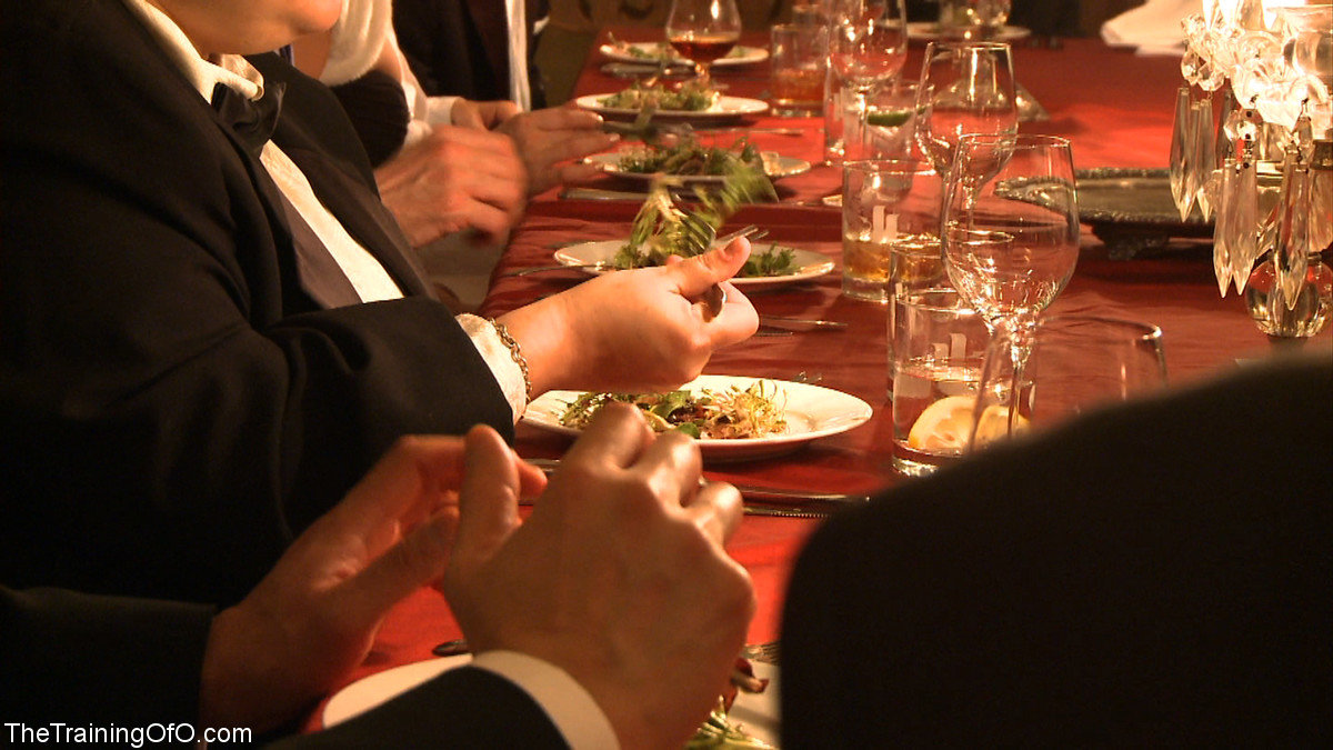 Female slaves treating the house guests to kinky under the table oral action