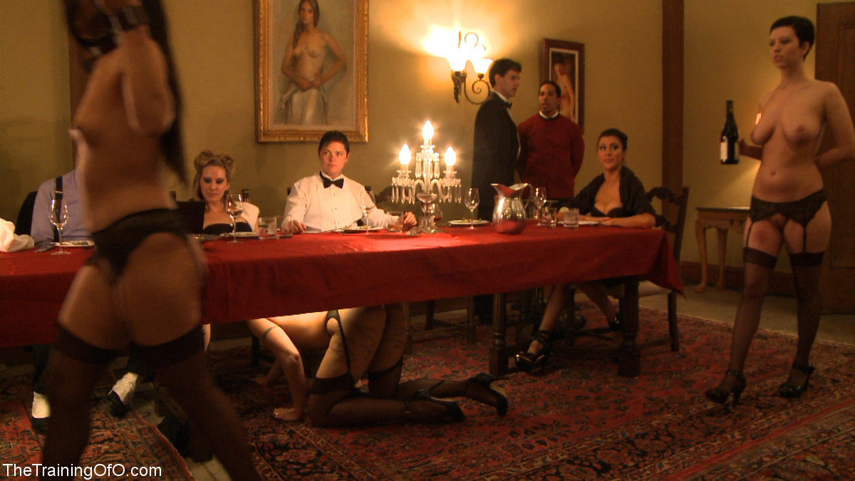 Female slaves treating the house guests to kinky under the table oral action