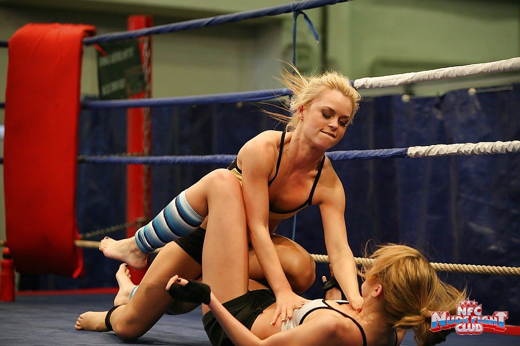Pretty lesbians gasping and stripping each other in the wrestling ring