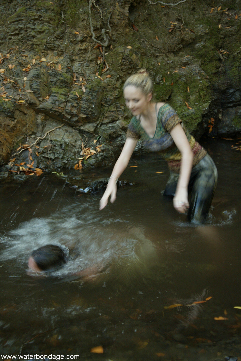 Busty virgin gets tortured by a blonde lezdom in outdoor water bondage action