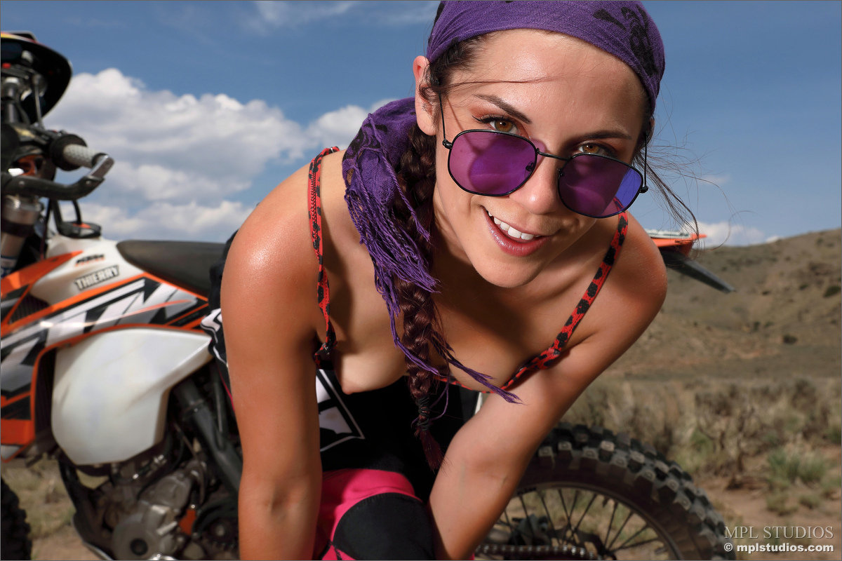 Beautiful girl gets off her motorcycle to model totally naked in back country