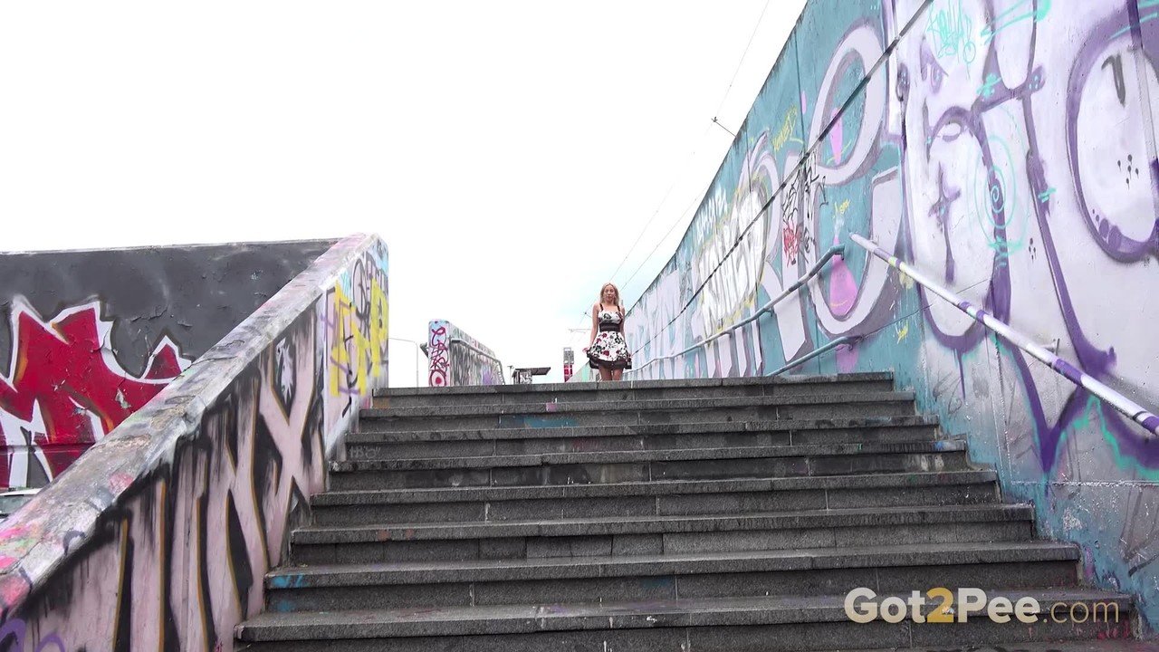 Blonde girl Emily Bright takes a piss on steps after being caught short