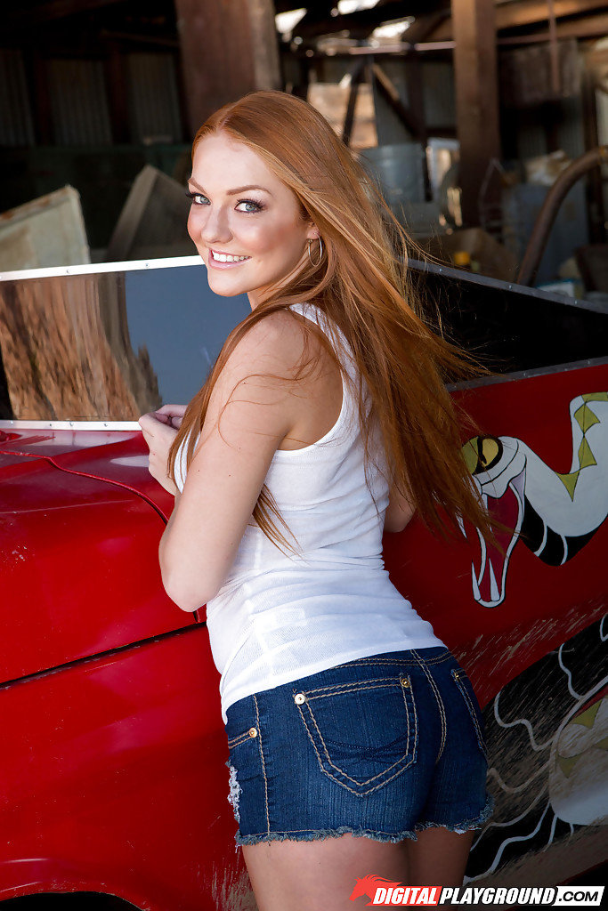 Natural redhead Farrah Flower undressing to pose naked atop car in garage