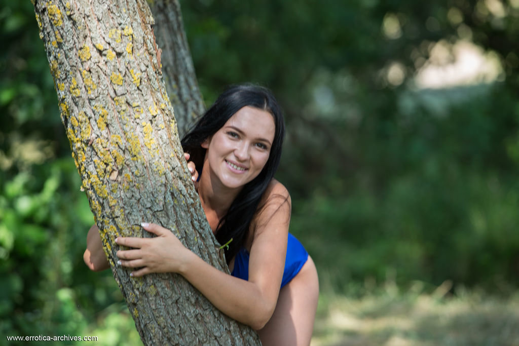 Dark-haired teen Indiana Blanc removes a swimsuit to pose nude in a brook