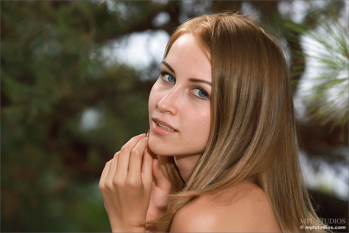 Sweet teen removes her bikini bottoms for nude poses at edge of a forest