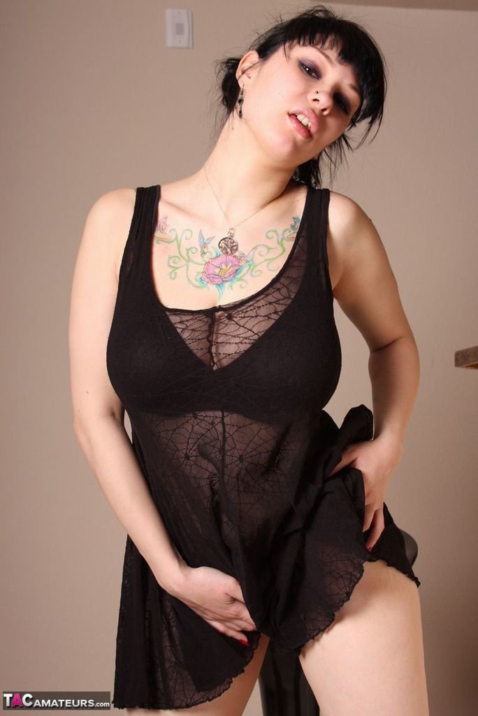 Tattooed amateur unveils her great tits and pierced nipples as she disrobes