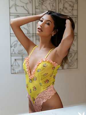 Dominique Lobito strips off her yellow bodysuit and poses naked on the table