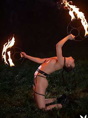 Elilith Noir showing off her nude body while playing with fire
