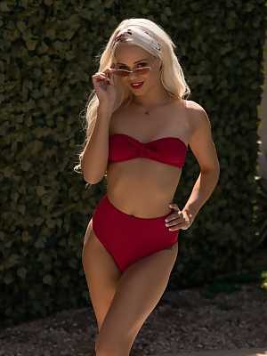 Blonde hottie Elsa Jean takes off her red bikini by the pool