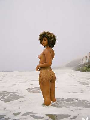Chocolate beauty Gillian Chan is nude on the beach