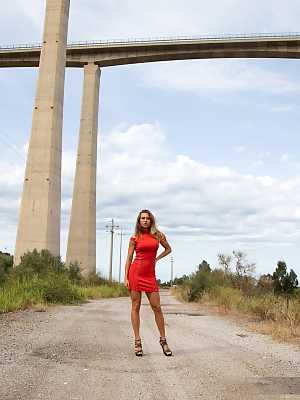 Busty Goldie drops off her sexy red dress under a huge viaduct