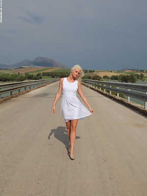 Grace in white dress all alone on the road