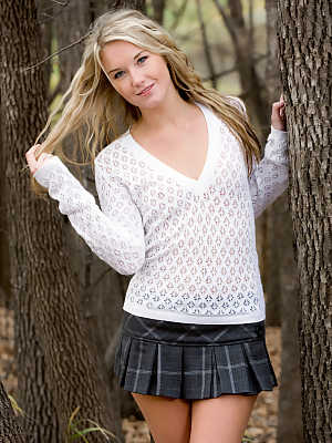 Jewell takes off her short skirt and sweater in the woods