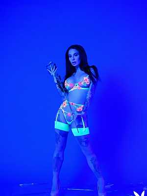 Heavily tattooed Joanna Angel participates in a sexy ultra violet photoshoot
