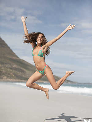 Katya Clover feeling playful without her green bikini on the beach