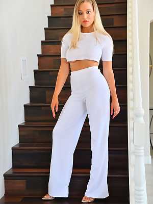 Blake Blossom removing her white shirt and pants on the stairs
