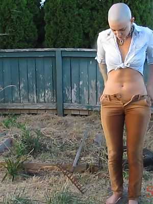Bald female Abigail Dupree strips and takes a piss while hoeing the garden