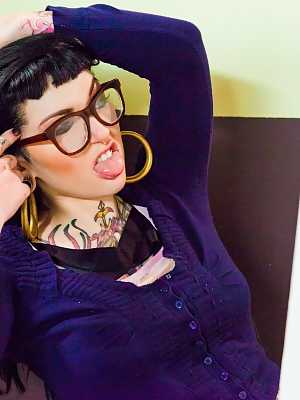 Glasses clad tattooed Adahlia on her knee sucking a great big dick in harness