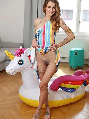 Tattooed girl Adelle Unicorn doffs a rainbow dress prior to masturbating