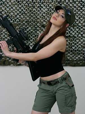 Sexy military MILF Adrenalynn shows her fakes & poses with an assault rifle