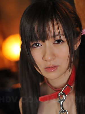 Japanese girl Ai Uehara wears her hair in pigtails in a collar and leash