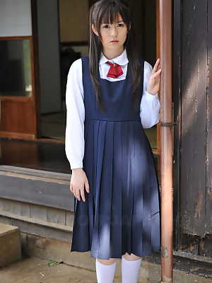 Charming Japanese babe posing in her cute school outfit in the garden
