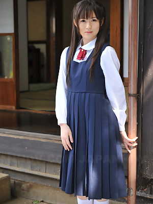 Charming Japanese babe posing in her cute school outfit in the garden