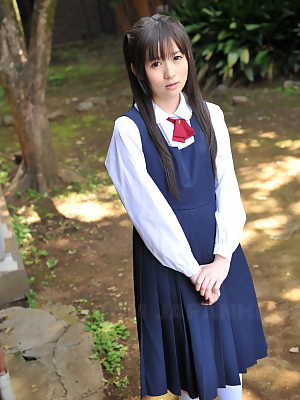 Charming Japanese babe posing in her cute school outfit in the garden