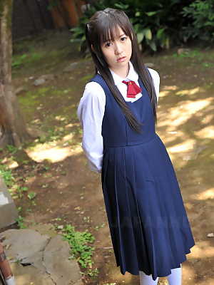 Charming Japanese babe posing in her cute school outfit in the garden