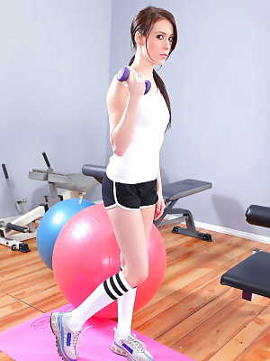 Shapely sports babe Jazy Berlin strips to knee high socks in the gym