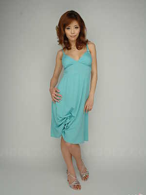 Japanese redhead Akane Hotaru cracks a smile while modeling a long dress