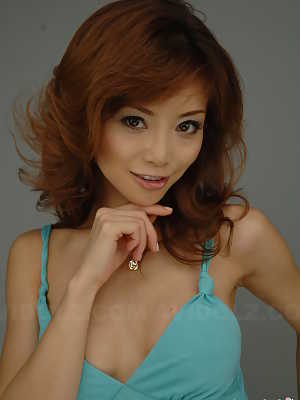 Japanese redhead Akane Hotaru cracks a smile while modeling a long dress