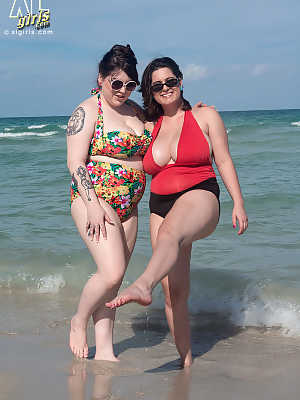 Mature BBW besties take out their massive big tits to play at the beach