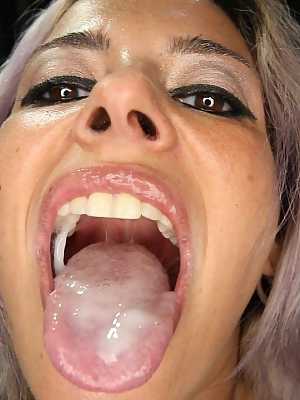 Purple-haired Alana appears in gloryhole scene sucking and swallowing 16 dicks