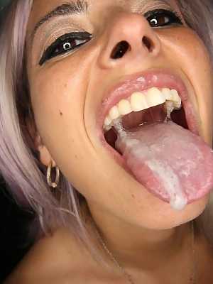 Purple-haired Alana appears in gloryhole scene sucking and swallowing 16 dicks