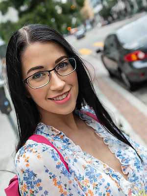 Dark haired geek removes her glasses and dress before riding a big cock