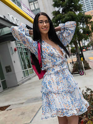 Dark haired geek removes her glasses and dress before riding a big cock