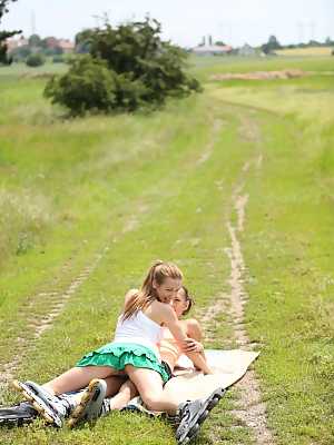 Lesbian lovers Alexis Crystal & El Storm kiss & toy on a blanket outdoors