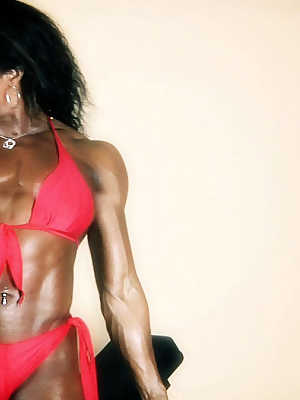 Ebony bodybuilder Alexis Ellis shows off her ripped physique in bikini bottoms